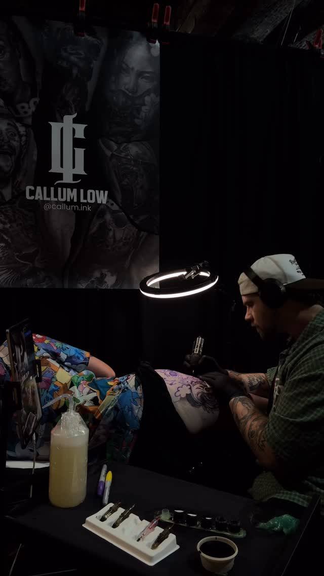 Callum tattooing a client at a convention booth
