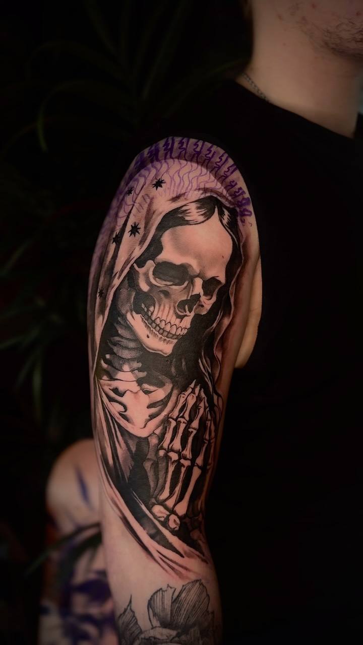 Hooded skeleton on an upper arm