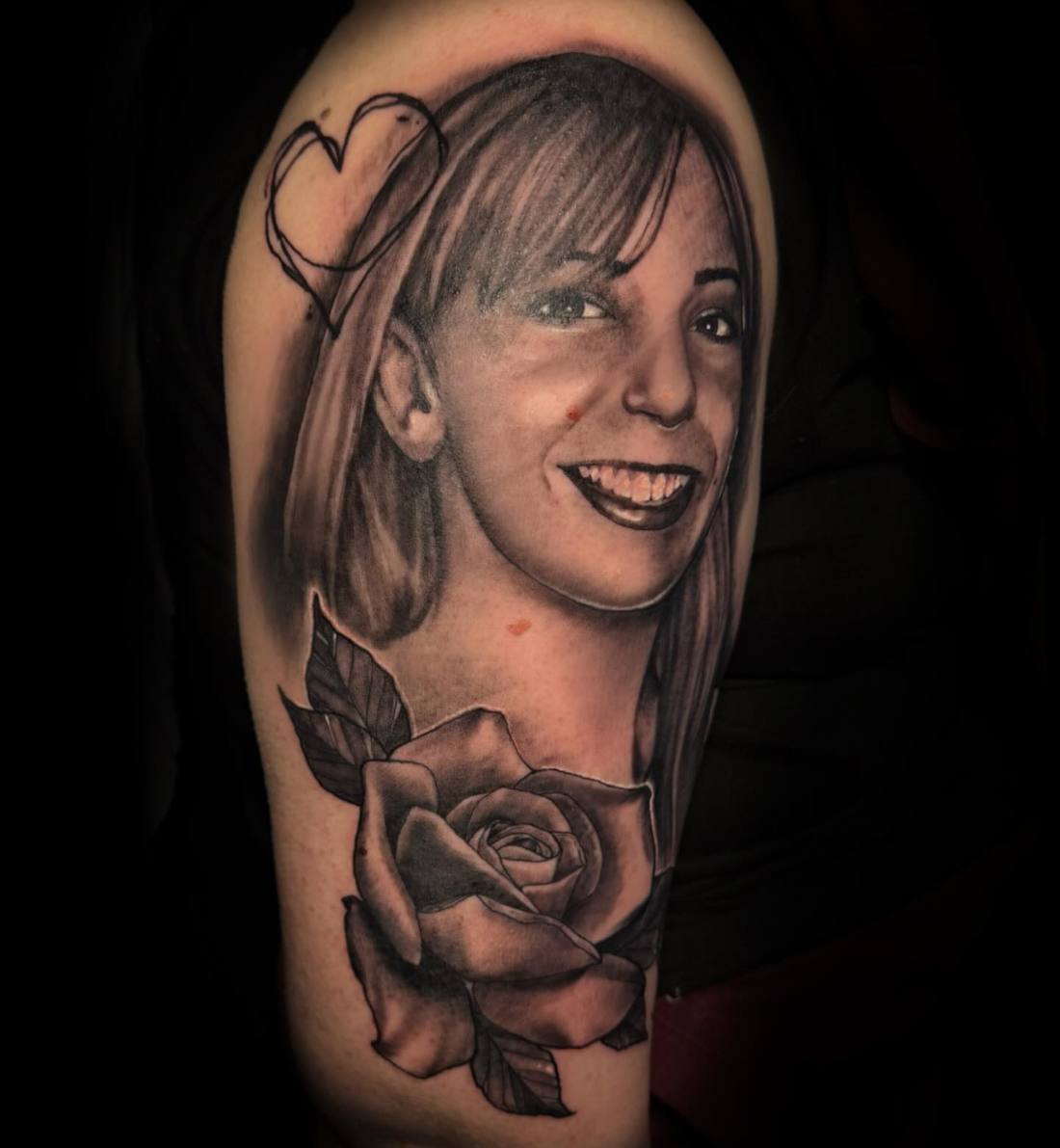 Smiling woman's portrait with a rose