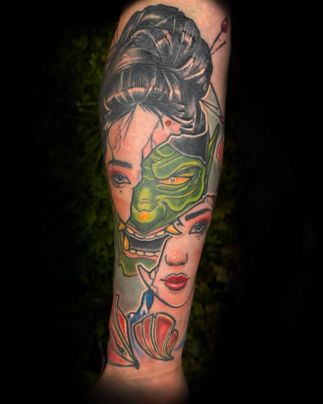 Colour geisha with a green mask on a forearm