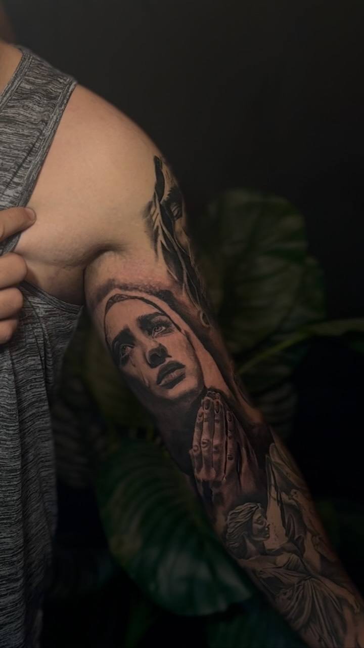 Praying woman on an upper arm