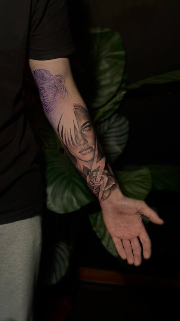 Woman's face and flowers on a forearm