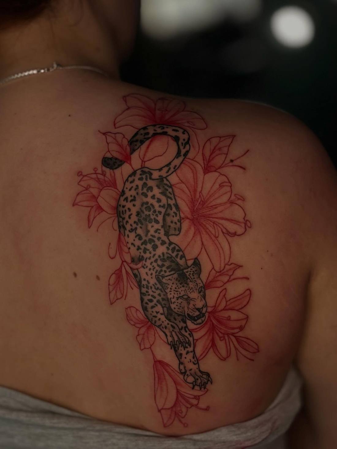 Leopard with red flowers down a back