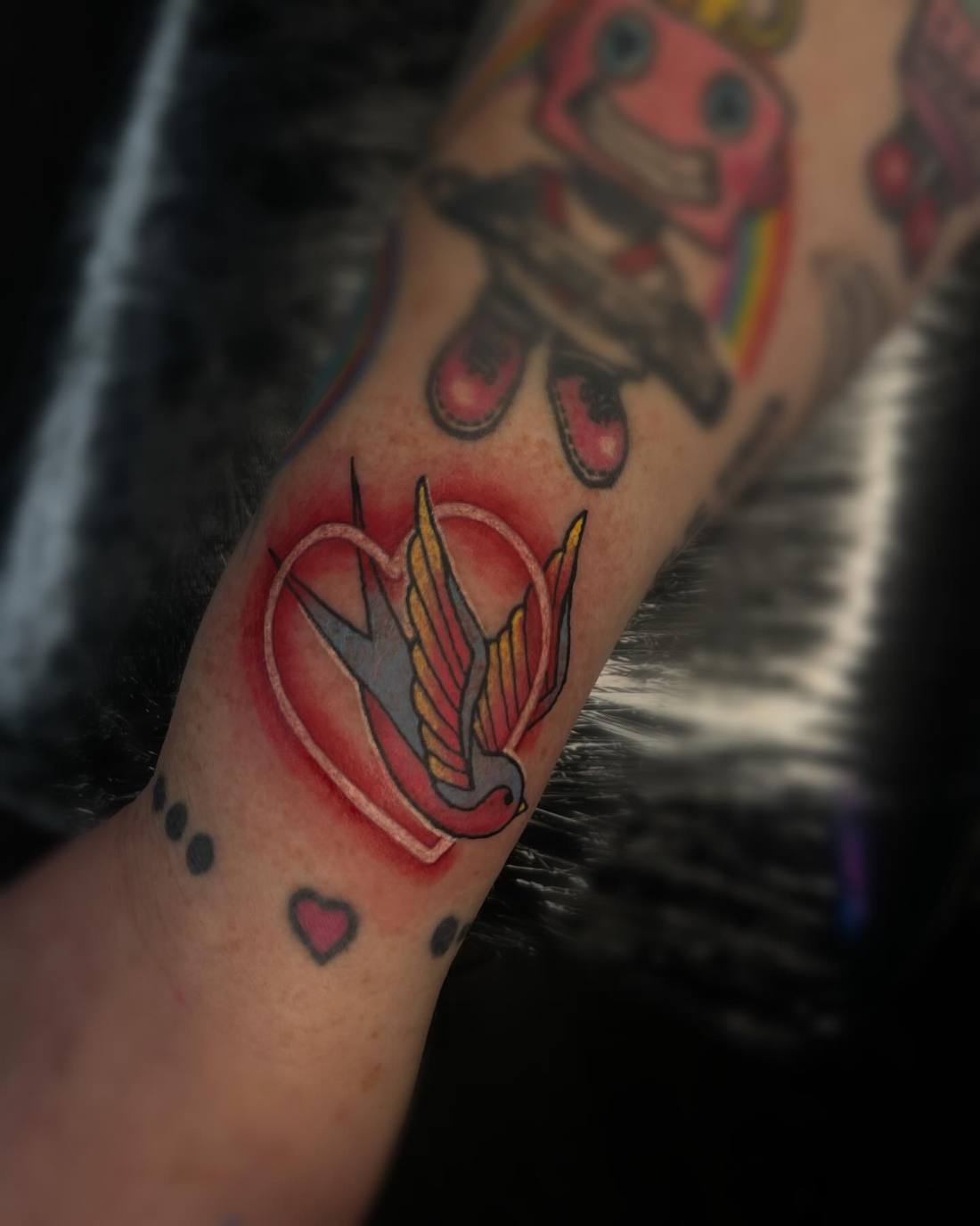 Traditional neon swallow with a heart