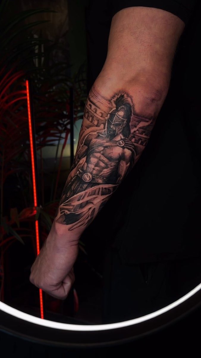Forearm tattoo of a warrior figure